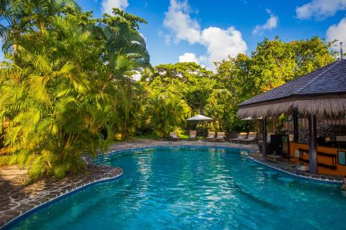 a pool at a resort with palm trees at East Winds St. Lucia- All Inclusive in Gros Islet