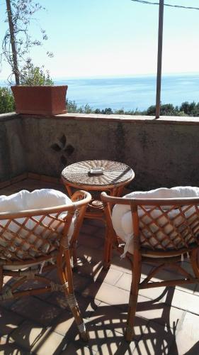 a patio with two chairs and a table and a table at B&B La Torretta in Maratea