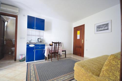a kitchen with a bed and a table in a room at Apartments Balic in Sveti Stefan