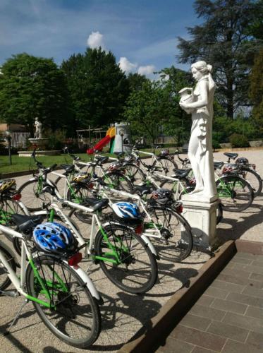 a bunch of bikes parked next to a statue at Hotel Daniela in Levico Terme