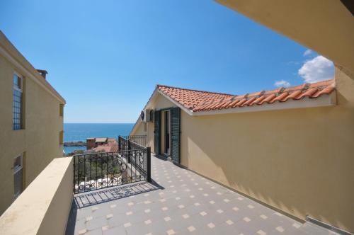 an empty balcony with a view of the ocean at Apartments Balic in Sveti Stefan