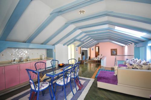 a kitchen and dining room with a table and chairs at Apartments Balic in Sveti Stefan