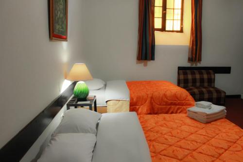 a bedroom with a bed and a couch and a chair at Hotel Casablanca in Cajamarca