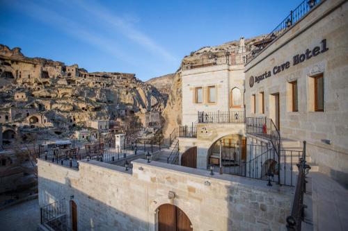 a building with a mountain in the background at Agarta Cave Hotel in Goreme
