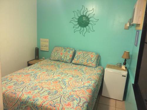 a bedroom with a bed with a spider on the wall at Palmetto Guesthouse in Culebra