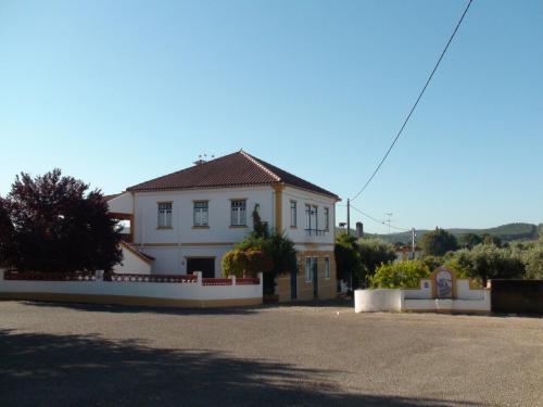 a white house with a fence in front of it at A Tejada in Ortiga