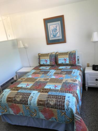 a bedroom with a bed with a quilt on it at South Beach Inn - Cocoa Beach in Cocoa Beach