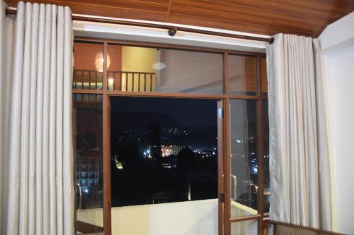 a window with a view of a city at MANUDI Glenfallsedge Rest in Nuwara Eliya