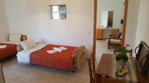 a bedroom with a bed with two towels on it at Sofia Studios & Apartments in Georgioupolis