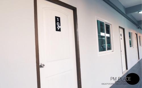 a white door with the number eight on it at PM Place in Bangsaen