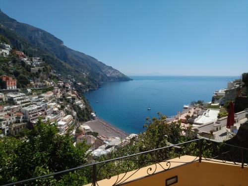 a view of a city and the ocean from a balcony at Casa Hellen Positano center in Positano