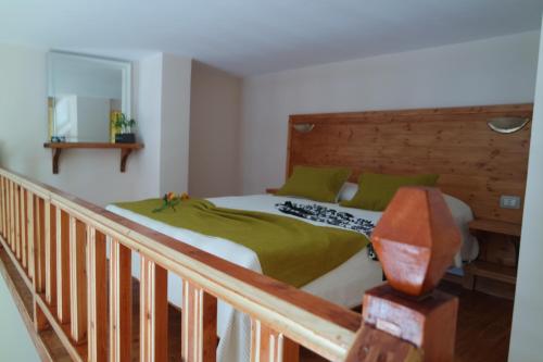 a bedroom with a bed with green pillows at Relax Apts Saranda in Sarandë
