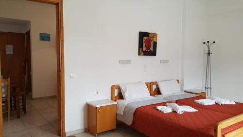 a bedroom with a bed with towels on it at Sofia Studios & Apartments in Georgioupolis