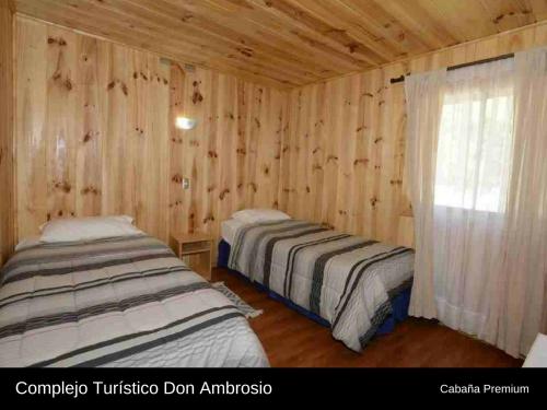 Ένα ή περισσότερα κρεβάτια σε δωμάτιο στο Cabanas Turismo Don Ambrosio