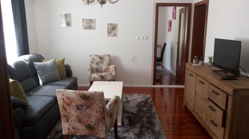 a living room with a couch and a table at Apartman EL in Sarajevo