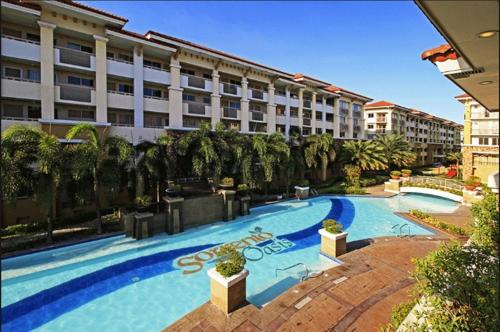 a large swimming pool in front of a building at 2 BR Sorrento Oasis in Manila