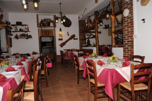 een restaurant met tafels en stoelen met roze tafelkleden bij Al Fontanone in Cecchina