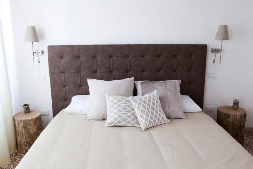 a bedroom with a large bed with pillows at B&B Al Pozzo di Luce in Venice