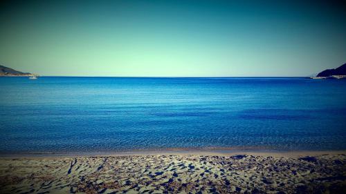 a view of the ocean with a sandy beach at Hotel Punto Verde in Marina di Campo