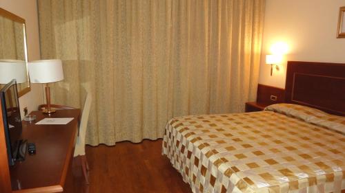 a hotel room with a bed and a window at Hotel Marconi in Bentivoglio