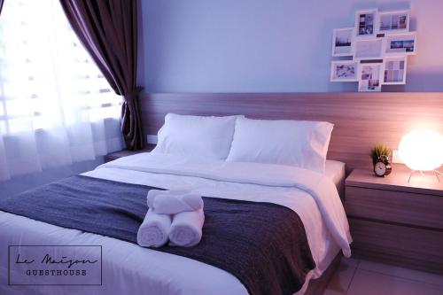 a white teddy bear sitting on top of a bed at Le Maison GuestHouse Ipoh Majestic in Ipoh