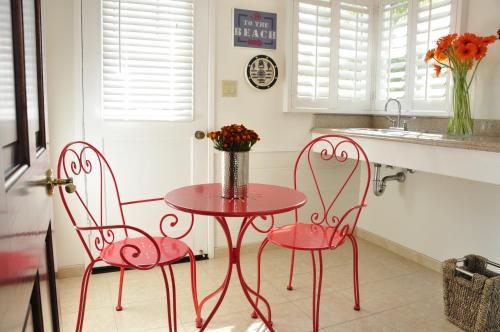 two pink chairs and a table in a kitchen at The Eagle Inn in Santa Barbara