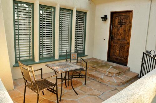 a dining room with a table and chairs and a door at The Eagle Inn in Santa Barbara