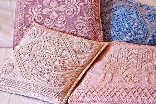 a group of quilt blocks sitting on a bed at Agriturismo Sa Suerera in Olmedo