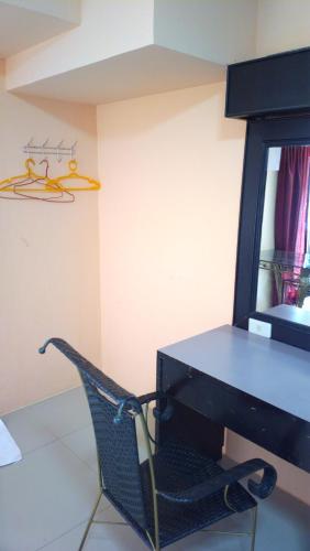 a black desk with a chair next to a mirror at Hua Hin Euro City Hotel in Hua Hin