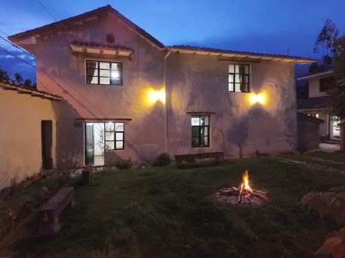 a fire in the yard of a house at night at Hospedaje La Florida in Urubamba