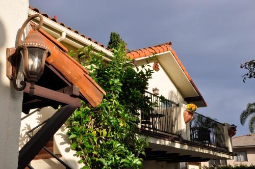 a building with a balcony with plants on it at The Eagle Inn in Santa Barbara