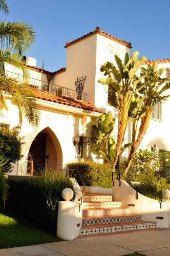 a white house with palm trees in front of it at The Eagle Inn in Santa Barbara