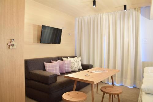a living room with a couch and a table at Pension Alpenfluh in Lech am Arlberg
