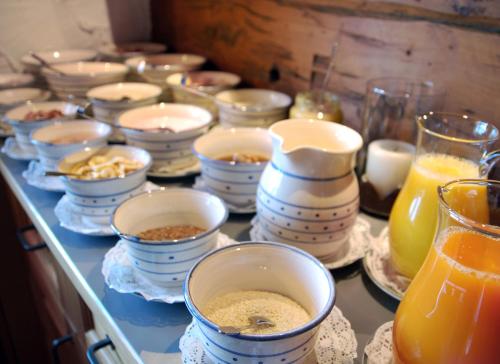 a counter topped with bowls of food and other ingredients at Pension Alpenfluh in Lech am Arlberg