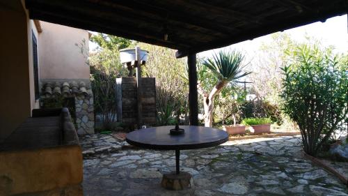 a patio with a table in the middle of a yard at Silva Garden in San Vito lo Capo