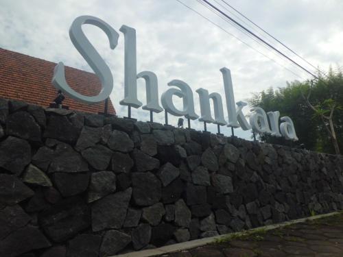 a sign for the train station on a stone wall at Shankara Borobudur in Borobudur