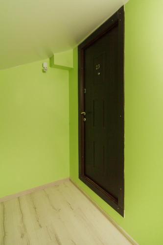an empty room with a black door and green walls at Apartments near Deribasovskaya in Odesa