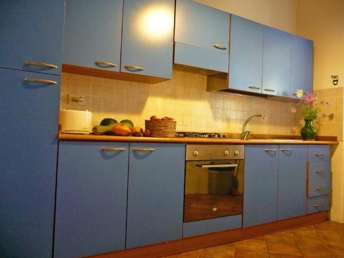 a kitchen with blue cabinets and fruits on the counter at Casa Rondini in Montegabbione