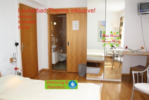a room with a door and a room with a bedroom at Hotel Paradis-Leukerbad-Therme in Leukerbad