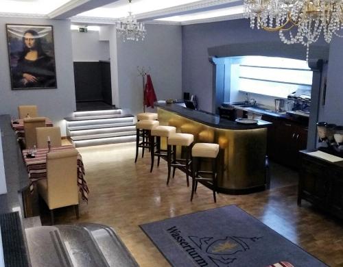 a bar in a restaurant with a bunch of chairs at Wasserturm Hotel Mannheim in Mannheim