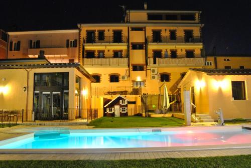 a swimming pool in front of a building at night at Appartamenti Brufa Civico 13/17 in Brufa