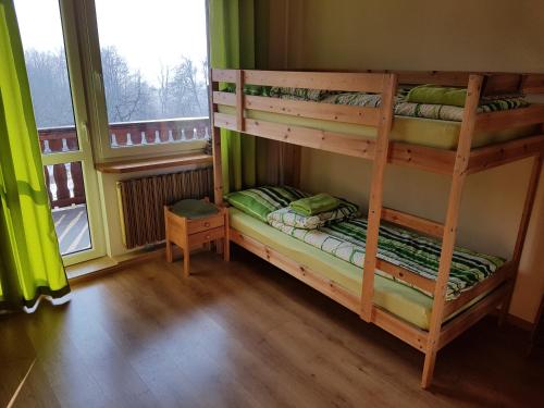 a bedroom with two bunk beds and a window at Pokoje Na Skalicy in Ustroń