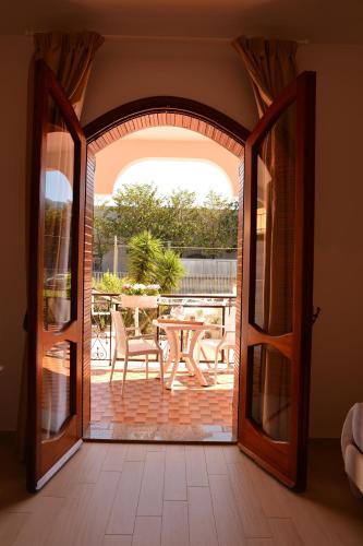 an open door to a patio with a table and chairs at Villa Miriam in Gragnano