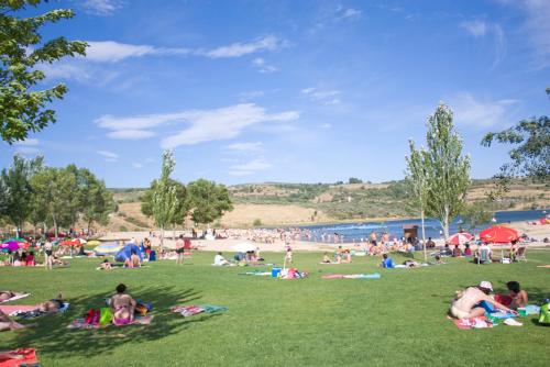 a group of people laying on the grass at a park at Hotel Muchacho in Macedo de Cavaleiros