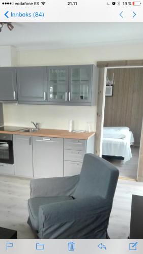 a kitchen with a chair in front of a counter at Kvamseter Lodge in Kvamseter