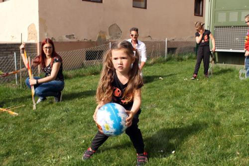 a little girl playing with a ball in the yard at Post Hostel For Youth, Students and Pilgrims in Lavamünd
