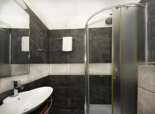 a bathroom with a sink and a shower at Andromeda Suites in Athens