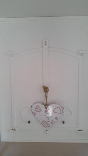 a clock is hanging from a white wall at B&B La Porta Vecchia in Monopoli