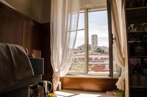 a window in a kitchen with a view of a building at Hotel Iris in Perugia