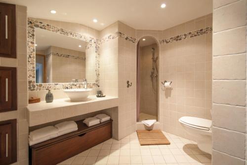 a bathroom with a sink and a toilet and a mirror at locations calenzana in Calenzana